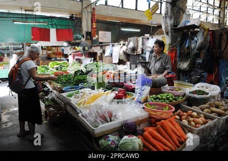 A vegetable vendor in a local market near Charoen Krung road in Bangkok, Thailand. Stock Photo
