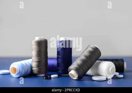 Different thread spools and buttons on color table Stock Photo