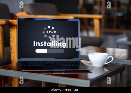 man installing Software Update On Mobile Phone And Laptop digital technology communication Stock Photo
