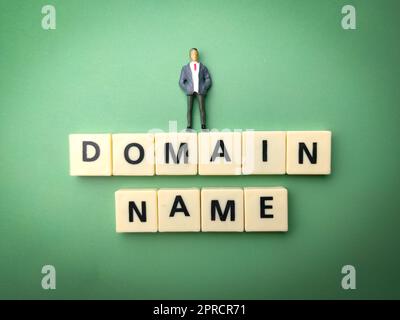 Miniature people and toys word with the word DOMAIN NAME Stock Photo