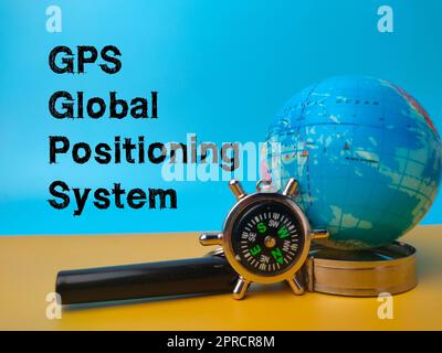Compass,magnifying glass and earth globe with the word GPS (Global Positioning System) Stock Photo