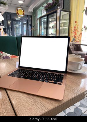 Mock up of generic laptop computer with blank copy space screen for your text or advertising content. Workspace of young freelancer: open notebook pc, Stock Photo