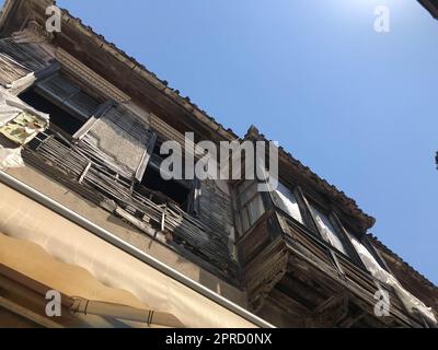 Stockholm narrow street. Orange, yellow houses and street lights. View from below of a cozy narrow medieval street yellow orange red buildings facades Stock Photo