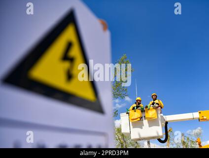 (230427) -- LHASA, April 27, 2023 (Xinhua) -- Zhaxi Nyima (R) and his apprentice practice operation skills on overhead high-voltage live wire in Lhasa, capital of southwest China's Tibet Autonomous Region, April 26, 2023. Zhaxi Nyima has been working in the field of power supply for about 30 years. In 2016, he took the training class and got the certificate, becoming the first person qualified of doing live-wire work in high altitude area in State Grid Tibet Electric Power Company. Live-wire operation is an important technical measure to ensure reliable power supply, but it is also a very Stock Photo