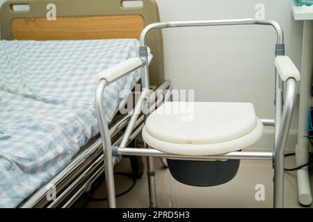 Flush toilet and shower chair in bathroom for old elder people. Stock Photo