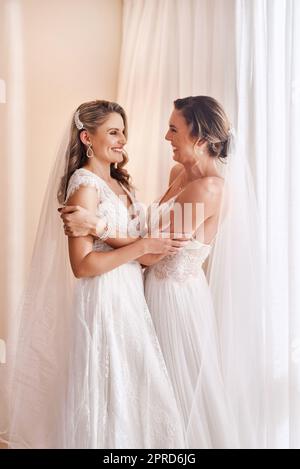 This is finally happening. two attractive young brides holding each other in excitement before their wedding. Stock Photo