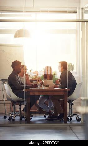 Working, thinking and brainstorming of office team in a boardroom meeting. Group of digital marketing workers work on a teamwork project together. Business colleagues sitting and planning advertising Stock Photo