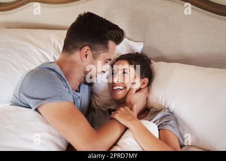 Loving you is the most precious feeling in the world. an affectionate young couple spending some quality time together in their bedroom at home. Stock Photo