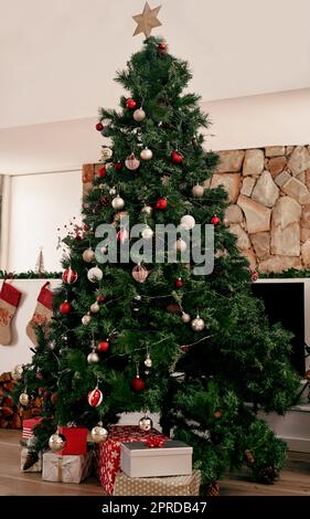 We did well on the decorating. a bunch of presents placed under a Christmas tree ready to be opened in the morning. Stock Photo