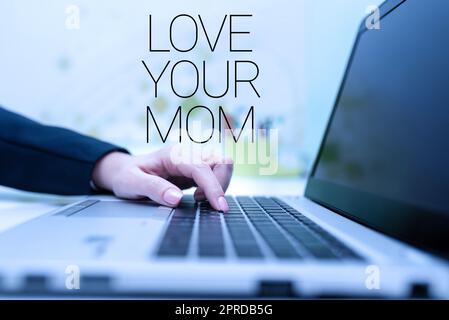 Text caption presenting Love Your Mom. Conceptual photo Have good feelings about your mother Loving emotions Businesswoman Typing Recent Updates On Lap Top Keyboard On Desk. Stock Photo