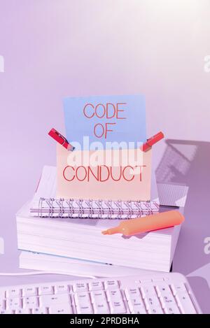Writing displaying text Code Of Conduct. Business showcase Ethics rules moral codes ethical principles values respect Important Messages Presented On Piece Of Paper On Desk With Books. Stock Photo