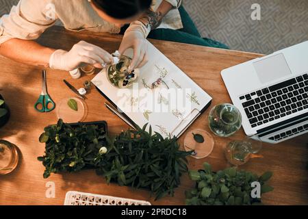 Make sure your plants get all the nutrients they need. an unrecognizable botanist adding a liquid nutrient to a water based plant inside a glass jar. Stock Photo