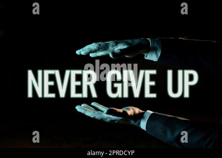 Text sign showing Never Give Up. Business overview Keep trying until you succeed follow your dreams goals Businessman Presenting Important Informations Between Hands. Stock Photo