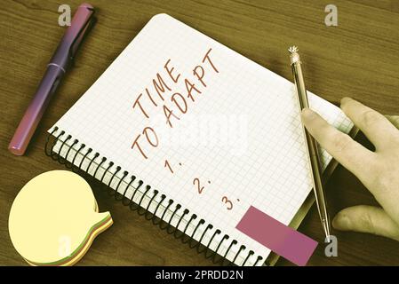 Writing displaying text Time To Adapt. Word for Moment to adjust oneself to changes Embrace innovation Man Showing Recent Updates On Notebook On Desk With Notes And Pencils. Stock Photo
