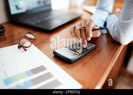 Your finances say a lot about your state of affairs. a businesswoman using a calculator while going over financial paperwork at her desk. Stock Photo