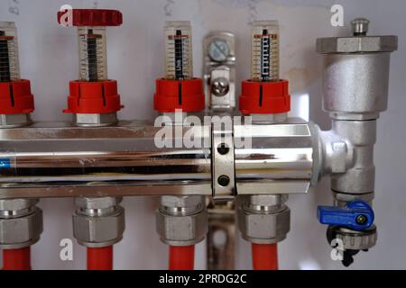Heating system manifold valves for heat flooring and water supply in a country house. Pipes collector in a building under construction Stock Photo