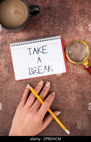 Text sign showing Take A Break. Business approach Resting Stop doing something recreation time get out of work Hand Of Woman Spiral Notebook, Magnifying Glass And Coffee Cup On Wood. Stock Photo