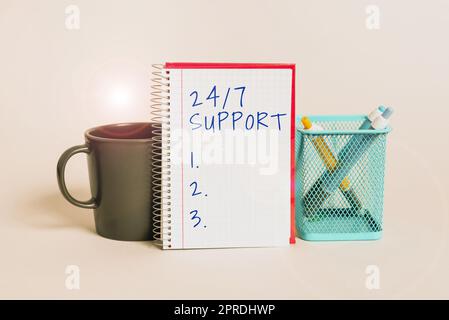 Conceptual caption 24 7 Support. Conceptual photo Giving assistance to service whole day and night No downtime Cup, Notebook With Important Message And Pencil Case On Desk Stock Photo