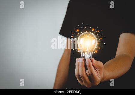 Man holding light bulbs ideas innovation technology and creative business concept. Stock Photo