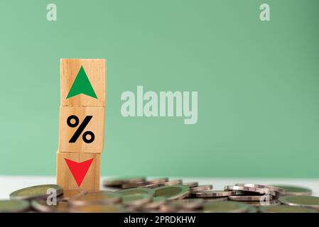 Business finance and banking investments economy stack coin inflation and arrow red and green with wood cube on desk. Stock Photo