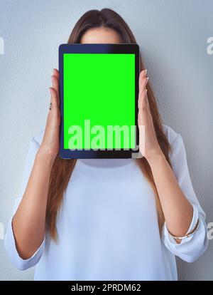 Anonymous profile online. an unrecognizable woman holding a digital tablet against a blue background. Stock Photo