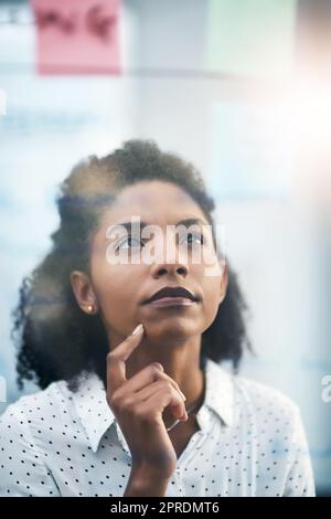 Shes onto something... a young businesswoman having a brainstorming session in a modern office. Stock Photo