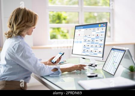 Employee Working On Calendar Schedule Stock Photo