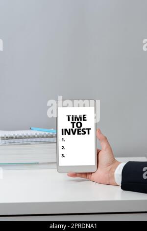 Conceptual caption Time To Invest. Conceptual photo Creation of capital capable of producing other goods Hands Of Woman With Blank Paper, Coffee Cup And Stationery Over Wood. Stock Photo