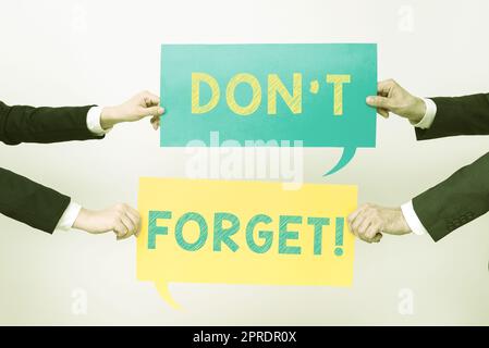 Conceptual caption Don T Not Forget. Internet Concept Know by Heart Think Back Fix in the Mind Refresh Memory Business Team Holding Two Important Ideas On Speech Bubbles On Both Sides. Stock Photo