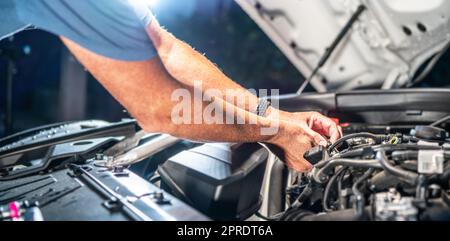 Auto mechanic working in garage. Repair service. Stock Photo