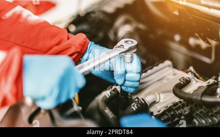 Auto mechanic working in garage. Repair service. Stock Photo