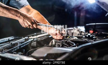 Auto mechanic working in garage. Repair service. Stock Photo