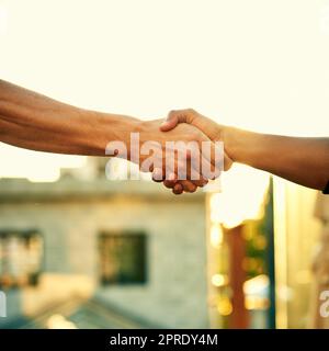 Stronger as a unit. two men shaking hands outdoors. Stock Photo