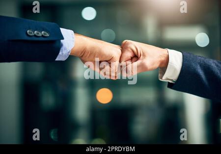 Partnership, teamwork and unity by hands fist bumping in support of a mission or goal. Business partners collaborating on a vision, community planning a strategy to support and succeed together Stock Photo