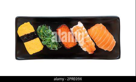Assorted sushi nigiri and maki set on black plate Stock Photo