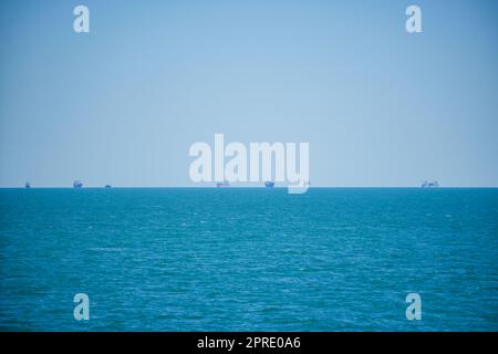 Commercial cargo vessels waiting to enter the port Stock Photo