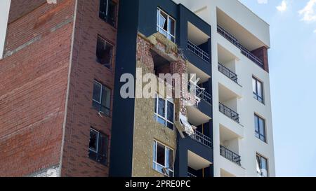 A residential building was damaged after being hit by a rocket. Holes from shells in a multi-storey building. Consequences of the war with Russia. Ukraine, Irpin - May 24, 2022. Stock Photo