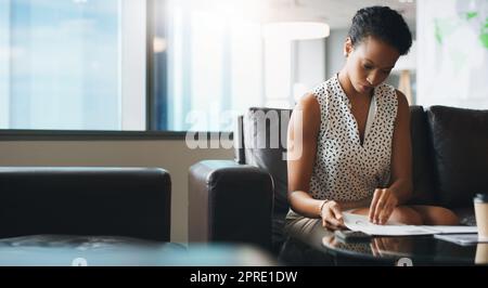 Preparing for a big meeting. a businesswoman working in a modern office. Stock Photo