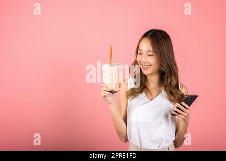 woman holding drinking brown sugar flavored tapioca pearl bubble milk tea Stock Photo