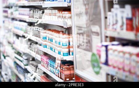 Well find a treatment off our shelf for you. shelves stocked with various medicinal products in a pharmacy. Stock Photo