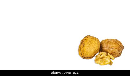 Two halves of a split walnut isolated on a white background. Stock Photo