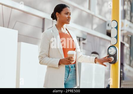 Crossing street, crosswalk or road at a pedestrian traffic light signal while waiting in a city outdoors. Young woman pressing button while traveling, commuting and walking in town on her way to work Stock Photo