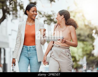 Friends walking and talking on university campus, having fun and laughing in the city. Carefree, happy and cheerful young female college students enjoying outdoor meeting, having takeout coffee. Stock Photo