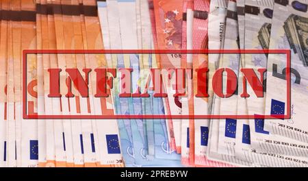 A stamp with the red lettering Inflation on numerous euro banknotes - Financial crisis concept in Germany and Europe Stock Photo
