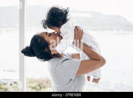 My whole heart is hers. a mother holding her baby daughter at home Stock Photo