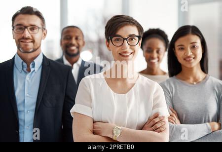 Smiling and modern team of business workers happy about teamwork collaboration and success. Portrait of successful office group ready to work. Colleagues standing together with a sense of community Stock Photo