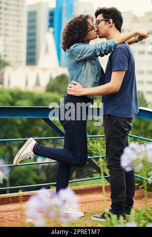 How lucky we are to have found love so young. a teenage couple kissing outdoors. Stock Photo