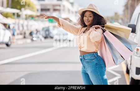 Retail, shopping and taxi with black woman in city for travel, luxury and fashion in urban street. Happy, sales and gift with customer and discount ba Stock Photo