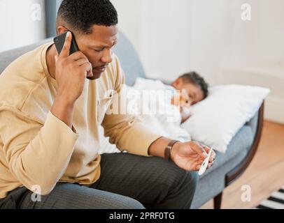 Worried father concerned, caring for sick son calling a doctor and taking temperature check of his sleeping kid at home. Parent consulting with professional and taking care of child with fever Stock Photo