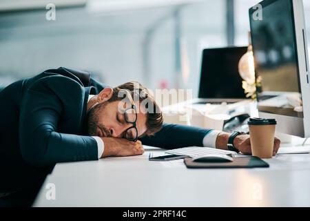 https://l450v.alamy.com/450v/2prf14c/the-busy-day-has-knocked-him-out-a-tired-young-businessman-sleeping-on-his-desk-inside-of-the-office-during-the-day-2prf14c.jpg